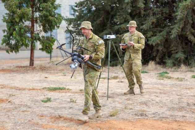 No. 3 Security Forces Squadron Leading Aircraftman Rhys Mitting (left) and Chaddyn Bray prepare the drone for operation from an airborne C-130J Hercules.
Defence