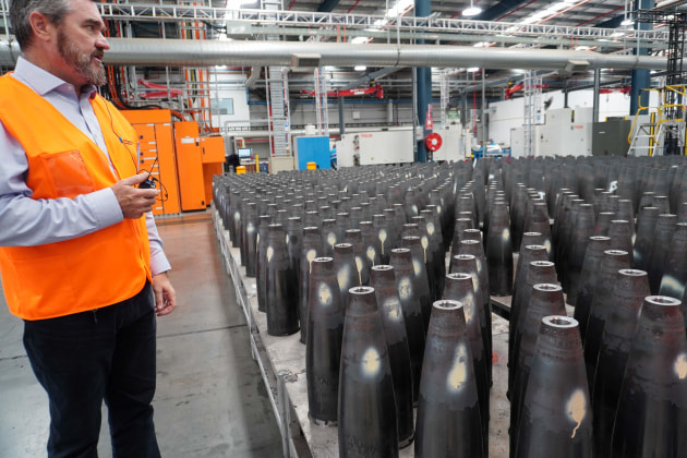 Maryborough plant manager Jeff Crabtree with 155mm artillery shells part way through the production process.

Credit: Max Blenkin