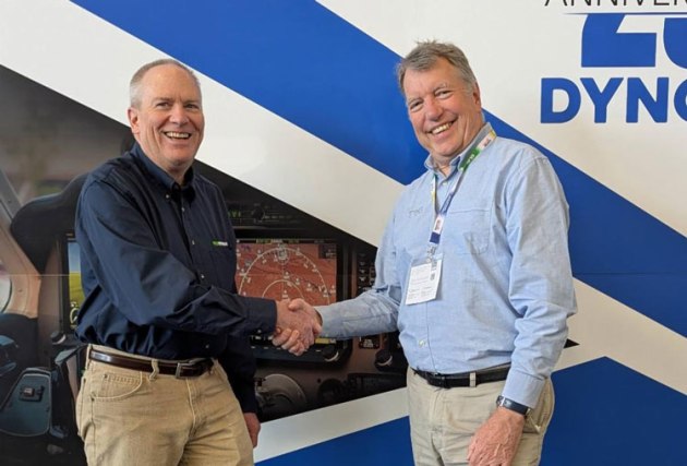 Dynon Chief Operating Officer Robert Hamilton (L) and Trig CEO Andy Davis (R) mark the merger of their companies with a hand shake. (Dynon Group)
