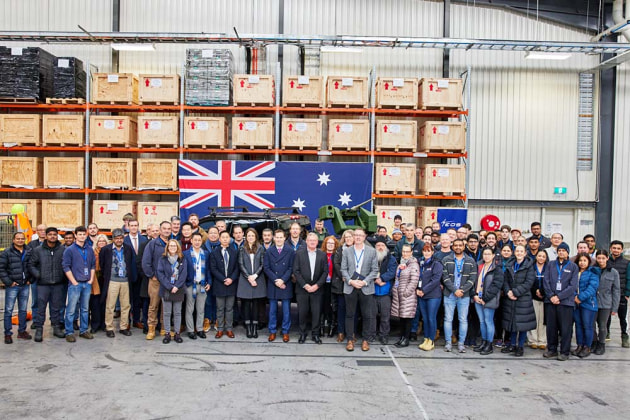 The EOS team at the R150 production line opening, with the R150 in the background mounted on the Denali truck. (EOS)