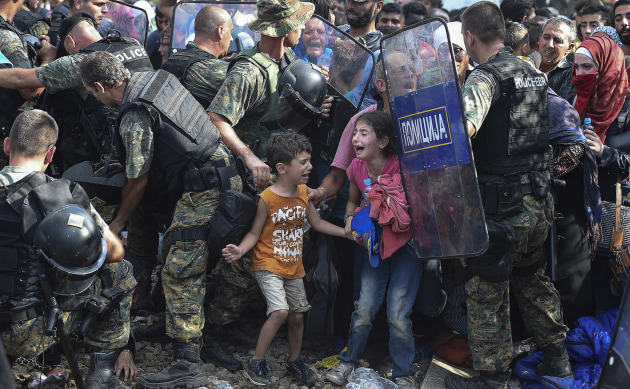 &copy; epa european pressphoto agency/Georgi Licovs. Macedonian police clash with refugees at blocked border, 2015, from the Untitled series, 2015, pigment inkjet print, 70.7 x 104 x 3.5 cm.