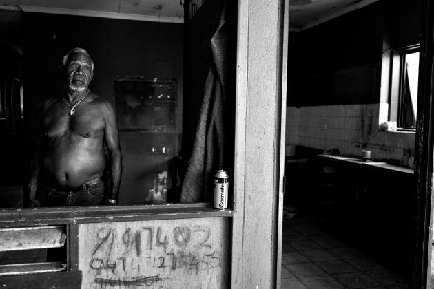 "My past was destroyed by alcohol and drugs. Now, I have a brighter future looking forward to set up an example for my future generation, my friends and family. Now, I feel free as the alcohol and drugs are no longer in my system. I am hoping the people come together as one happy family then Kennedy Hill would be one of the best communities in Broome town." Sandy Isaac standing in a condemned house in Kennedy Hill, which has now been demolished. Broome, Western Australia. &copy; Ingetje Tadros/Diimex.