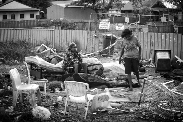 Sussanne and Jacquelin waking up in their new camp, at the other side of the fence, as the condemned house they used before in Kennedy Hill, has now been demolished. To this day, this camp is still being used by many homeless people. Broome, Western Australia. &copy; Ingetje Tadros/Diimex.