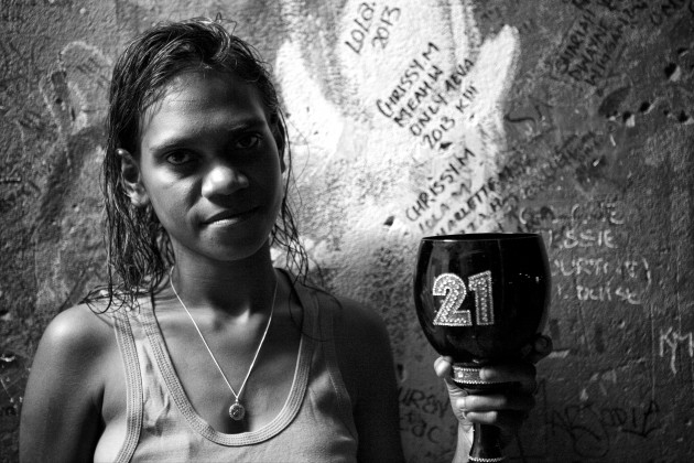 Chrissy holding a birthday cup which has the number 21 on it. Chrissy turned 21 years old, her mum Elaine Wiggan said to me; "She is a loving mum and does not drink. She stays home and looks after her two kids." Broome, Western Australia. &copy; Ingetje Tadros/Diimex