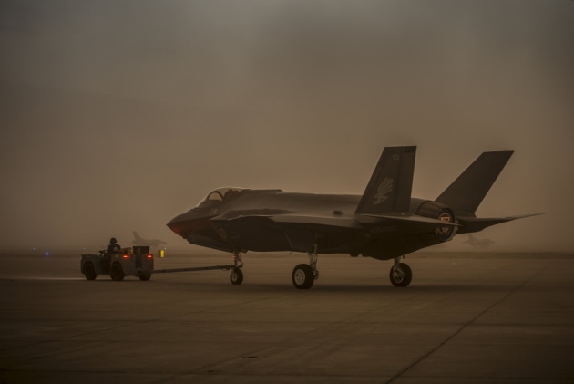 Lockheed Martin and Royal Australian Air Force maintenance personnel prepare to tow an Australian F-35A aircraft during a sudden dust storm at Luke Air Force Base, Arizona, USA. Defence