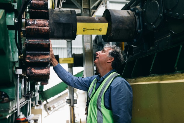 Husk Rum founder Paul Messenger inspecting the husk mill.