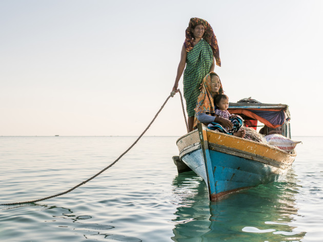 Reducing numbers of Bajau Laut live a traditional life entirely at sea. Families like this one do not have land-based houses, but instead live on tiny traditional wooden boats called Lepa Lepa. &copy; Mark Lehn.