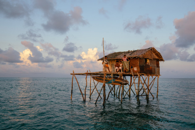 Today, most Bajau Laut have moved to the islands but they are still strongly connected to the sea. They live in villages of frail stilt houses made from wood and nearby resources over the Celebes Sea. They lack many creature-comforts like electricity, gas and running water. Wooden planks between the houses connect their community. &copy; Mark Lehn.