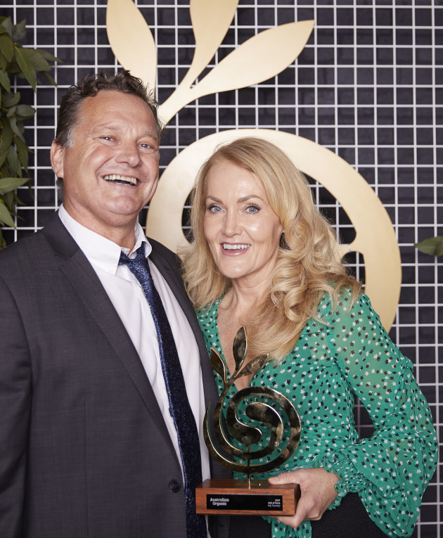 Martin Meek and Genevieve Flannery accept the Hall of Fame award on behalf of Mal Flannery.
