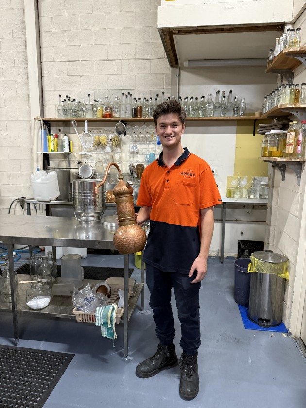 Ambra head distiller Nathan Iovino with the small still in the wet lab.