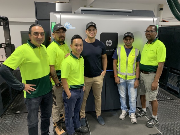 Matt Ellis (fourth from left) and members of his printing team alongside the HP Indigo 20000 for printing flexible material for pouches.