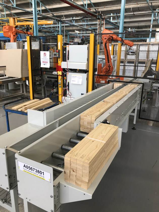 Wooden slat accumulation magazines each with six accumulation zones. Each magazine holds a different size slat.