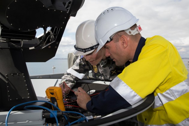 A RAN electronics technician assists a contractor from EM Solutions during a trial of the Tri-Band SATCOM terminal.
Defence