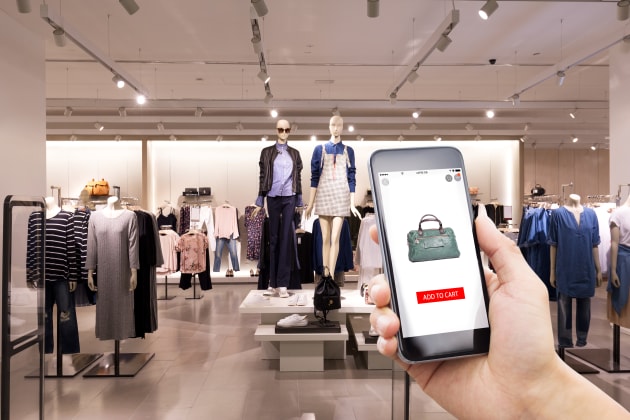 Man holding phone in store shopping