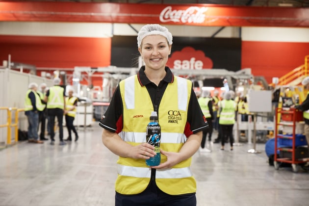 Jacinta Rogan, process technician CCA PSD, holds a Powerade bottle sporting the new closure.