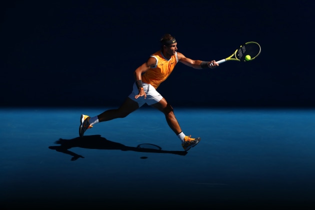 &copy; Kelly Defina. Rafael Nadal of Spain plays a forehand in the afternoon light, at Rod Laver Arena during the Australian Open
2019.