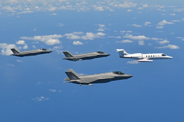 An Air Affairs Learjet flies in formation with F-35s. (Supplied)