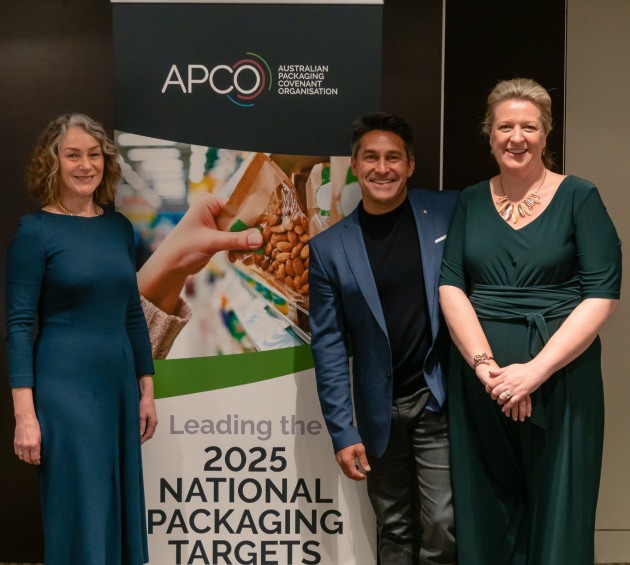 APCO chair Sam Anderson, TV personality Jamie Durie, and APCO CEO Brooke Donnelly with signage showing the new APCO logo.
