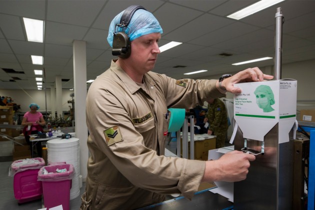 Corporal Sander Vloothuis operates surgical face mask machine.
Defence