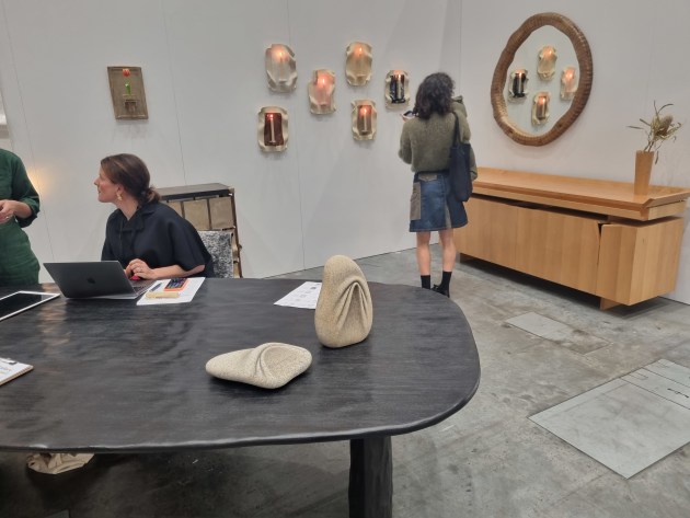 C. Gallery display. On the right, the beautiful Hand Operated Cabinet designed by John Wardle and made by Simeon Dux from celery top pine and brass, $78,000. In the foreground, Cavity Table by Benoit Viaene, 2021, described by the gallery as &lsquo;sculptured burnt tropical hardwood &ldquo;frake&rdquo;, $26,200. Photo: Linda Nathan