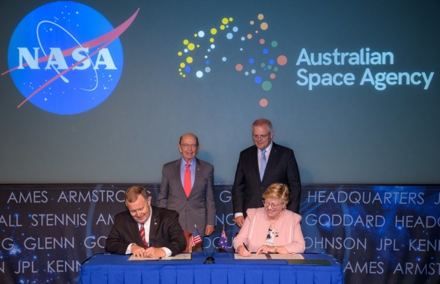 U.S. Secretary of Commerce Wilbur Ross and Australian Prime Minister Scott Morrison witness the signing of a letter of intent between NASA and the Australian Space Agency by NASA Deputy Administrator Jim Morhard, left, and Dr. Megan Clark AC, Head of the Australian Space Agency, right, at NASA Headquarters in Washington. Credit: (NASA/Joel Kowsky)