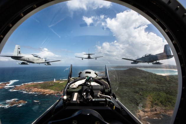 PC-9A aircraft from No 4 Squadron fly in tight formation over the Port Stephens Lighthouse near RAAF Williamtown, where one of Viasat's new facilities will be based. (SGT Guy Young/Defence)