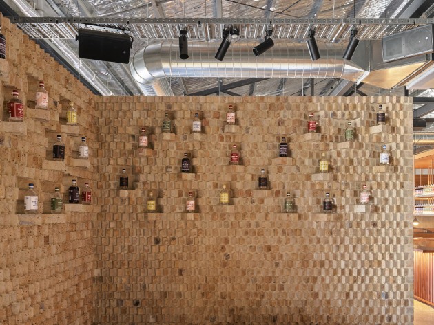 An organic wall made of recycled brick creates a display of gin in the Four Pillars Gin Shop. (Image credit: Anson Smart)