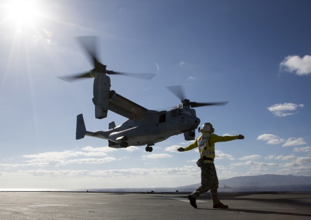 Leading Seaman Aviation Support Jamie Kennedy signals to a US Marine V-22 Osprey.
Defence