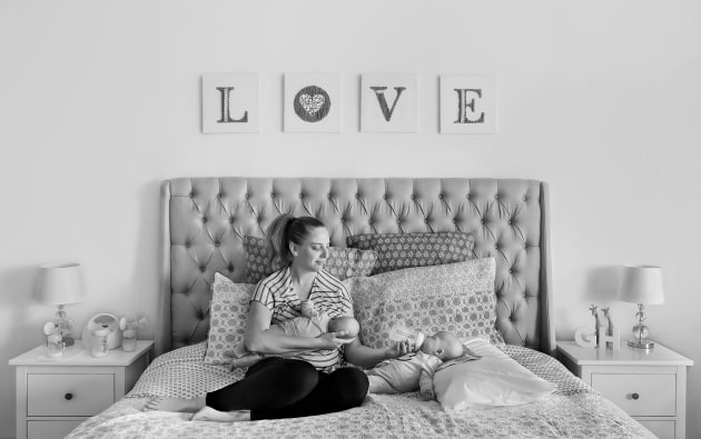 &copy; Karen Pfeiffer APP M.Photog. 2019 AIPP SA Family Photographer of the Year. "The image of Nicole breastfeeding Henry, whilst bottle-feeding his twin brother, George, was taken as part of a series planned to document the first year of their lives. The image&rsquo;s power is in the simple portrayal of a Mother&rsquo;s love, entwined with the hard work she faces on a daily basis."