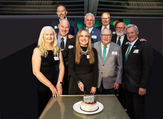 Nerida Kelton (centre) cuts the birthday cake with AIP presidents (from left) Carol Kilcullen-Lawrence, George Ganzenmuller, Craig Wellman, John Bigley, Terry Waterson, Mark Kerr, Ralph Moyle and Pierre Pienaar.