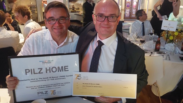 Gift: Thomas Pilz presents a cheque for the tna foundation's birthing building in Papua New Guinea to Phil Egglestone