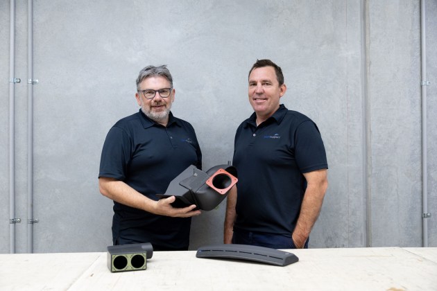 Plane Support Director of Engineering, Jason Hazell, and Director of Manufacturing and Maintenance, Fraser Wright holding 3D printed 214B helicopter parts. (McDermott)