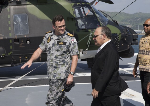 Commanding Officer HMAS Adelaide Captain Jonathan Earley talks with PNG Prime Minister Peter O'Neill.
Defence