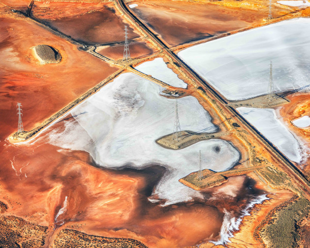 &copy; David Dahlenburg. 2019 AIPP SA Emerging Photographer of the Year. "I was motivated to document the remnants surrounding the decommissioned Port Augusta coal fired power station before it was covered over with top soil to reduce airborne  pollution. This image was captured from a light plane. It depicts the human impact on the environment and the scars that are left behind from heavy industry."