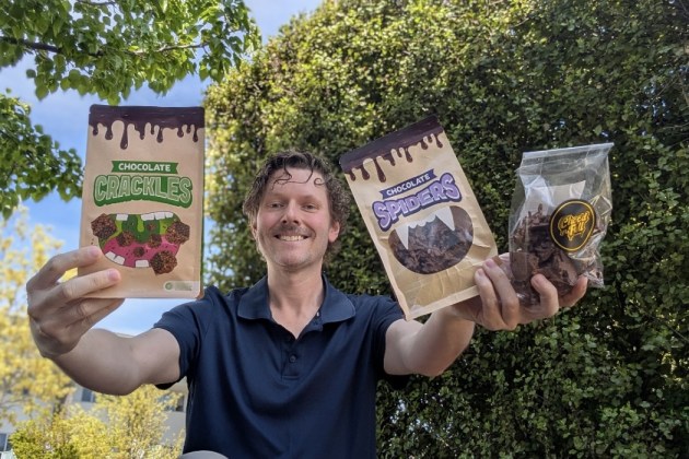Aussie Chocolates' founder Nathan Beer showing the three iterations of the pack, with the final iteration left.