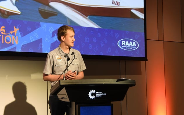 Teen pilot Byron Waller behind the rostrum.