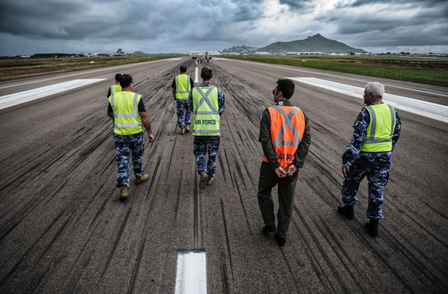Aerodrome Reporting Officer course participants walk the cross strip of RAAF Base Townsville.
Defence