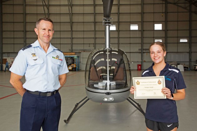 (l-r) Squadron Leader Peter O&rsquo;Connell, the Senior Air Traffic Controller at No. 452 Squadron RAAF Base Townsville after presenting helicopter student Georgie Arnold with her first solo certificate. (Department of Defence / CPL Colin Dadd)