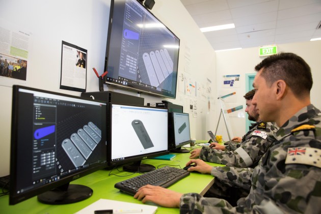 Royal Australian Navy personnel, Lieutenant Kit Low (foreground), from HMAS Waterhen and Leading Seaman Electronics Technician Callum Spence, from HMAS Kuttabul, use Computer Aided Design to develop ideas at the Centre for Innovation, Fleet Base East in Sydney.