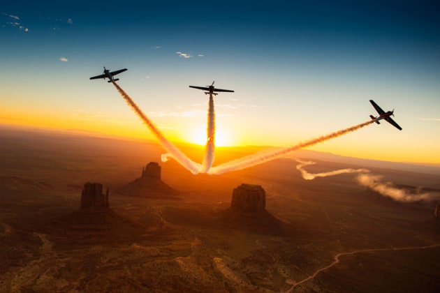 American Kirby Chambliss, France's Nicolas Ivanoff and German pilot Matthias Dolderer over Monument Valley in Utah as they ferry their race aircraft to Fort Worth. (Joerg Mitter / Red Bull Content Pool)