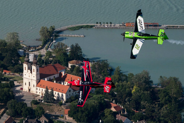 Britain's Ben Murphy and Frenchman Francois Le Vot fly over a Bendictine abbey on the shores of Hungary's Lake Balaton. (Daniel Grund / Red Bull Content Pool)
