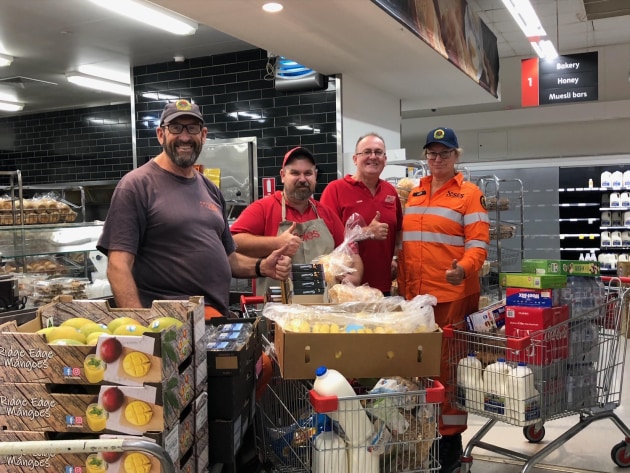 The team from Coles Batemans Bay meeting with Rural Fire Service firies with donations.