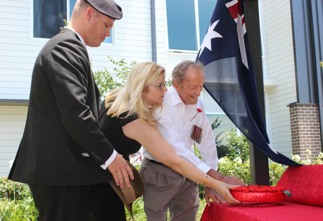 Rye Stott and Wendy Kane help Gordon Jamieson lay a wreath at Carinity Cedarbrook at Mudgeeraba. 
Carinity