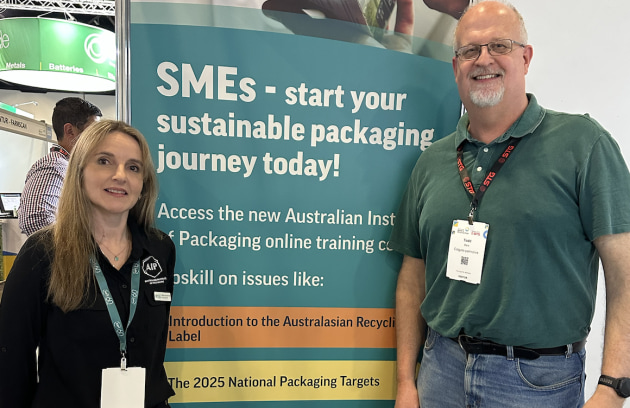 The AIP's Nerida Kelton shows a Todd Beck from Colgate-Palmolive the AIP stand.