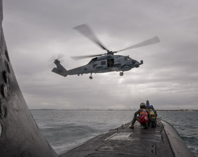 HMAS Ballarat's embarked MH-60R Seahawk helicopter conducts a forward passenger transfer with HMAS Rankin inside Cockburn Sound. Credit: Defence