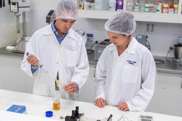 Senior Food Scientist Andrew Forrest and Consumer and Sensory Scientist Phillipa Lyons taking brew test samples.