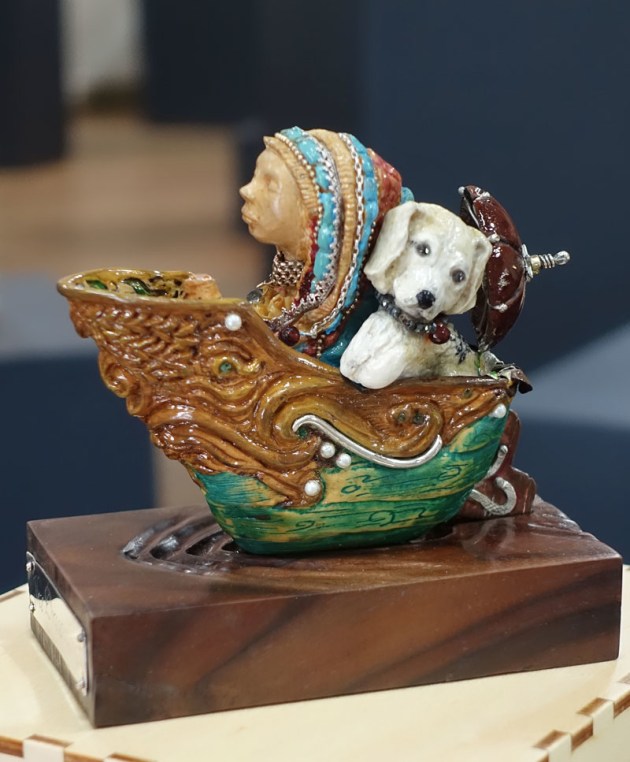 Shari Wright, Dreamboat, Huon pine, walnut, rosewood (Tiny Treasures). "The Dreamboat is a tiny elaborately carved boat, decorated with silver and gold-smithing and set with precious gems . The boat contains everything I would consider a perfect outing in a little boat would hold."
