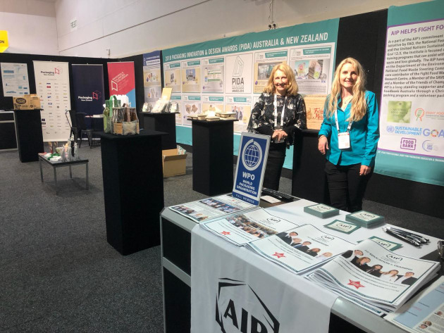 Packaging NZ executive director Sharon Humphreys and AIP executive director Nerida Kelton on the joint stand displaying the PIDA winners.