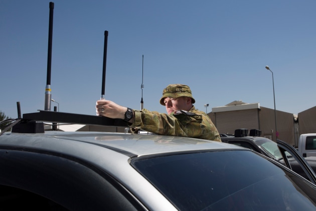 Major Geoffrey Small installs a silver shield electronic countermeasure device on a vehicle in Kabul, Afghanistan.
Defence