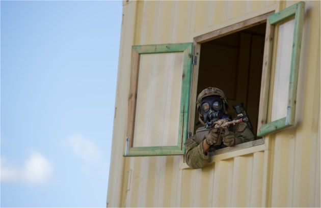 A soldier from 2nd Battalion RAR leans through a window to check an area during the Duke of Gloucester Cup at Singleton Military Area in 2015.
Defence